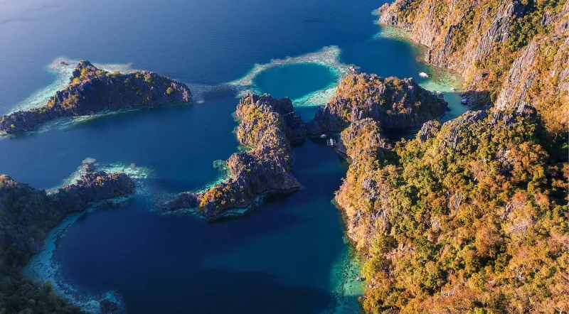 Aerial view of Coron Bay limestone karst islands and turquoise water, site of WWII Japanese shipwrecks